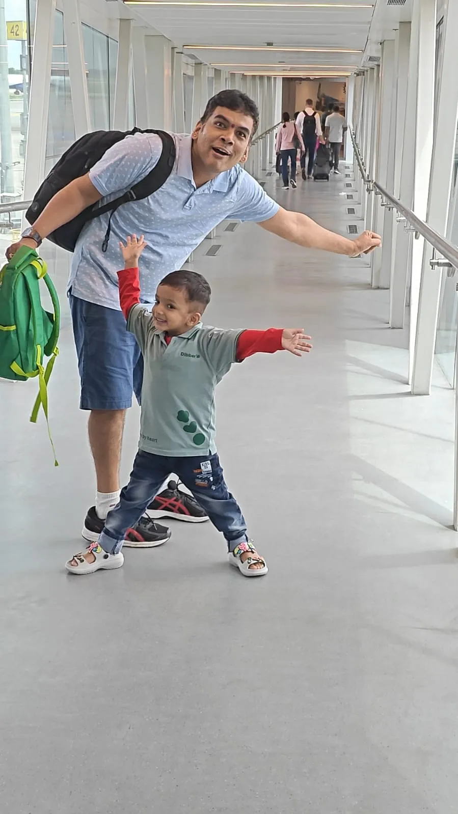 Phanindra and his son at the boarding gate, arms outstretched, before the flight from Hyderabad to Bengaluru.